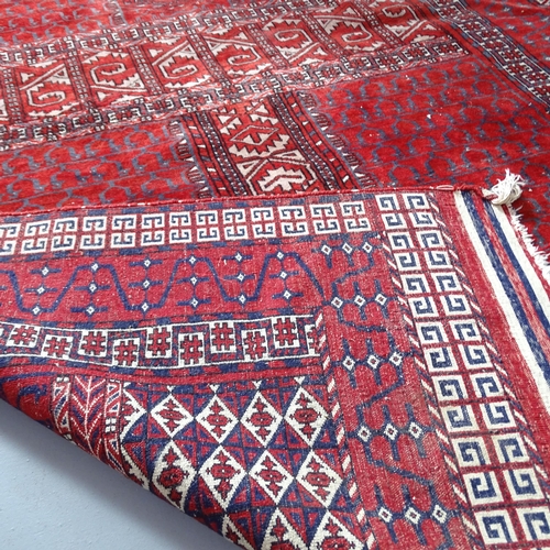 2314 - A red-ground Turkoman Engsi rug. 216x130cm.