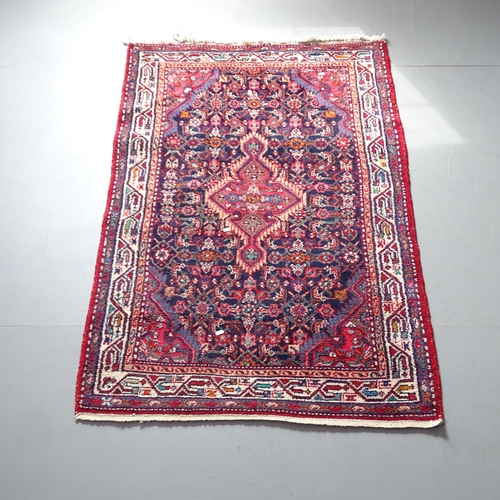 2317 - A red-ground Keshan rug. 168x106cm.