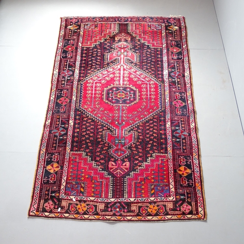 2318 - A red-ground Toserkan rug. 225x130cm.