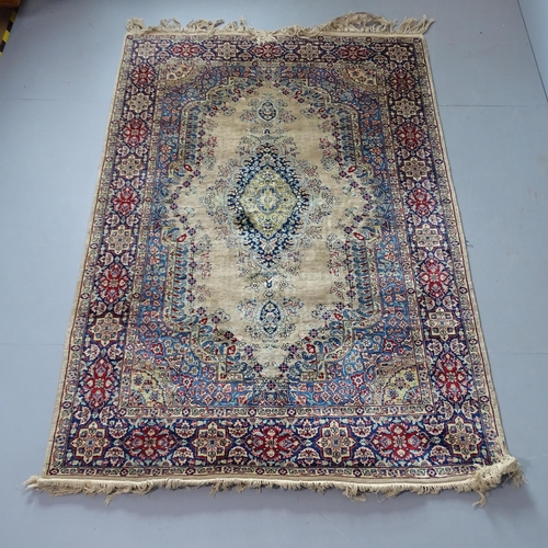 2329 - A cream-ground Kerman rug. 220x140cm