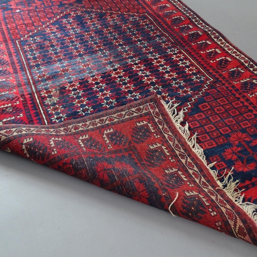 2330 - A red-ground Afghan rug. 183x115cm