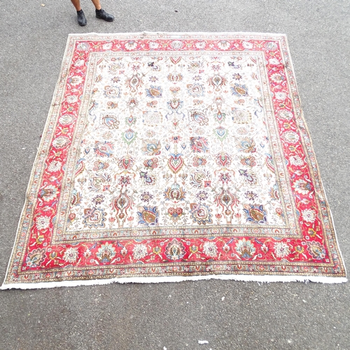 2348 - A red and cream-ground Tabriz carpet. 334x293cm.