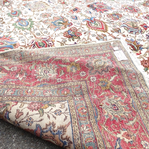 2348 - A red and cream-ground Tabriz carpet. 334x293cm.