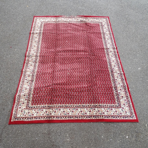 2349 - A red-ground Belgian machine-made carpet with oriental design. 334x236cm.