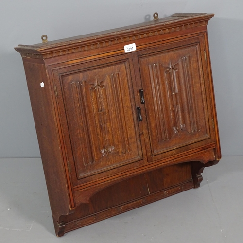 2297 - A 1920s oak hanging cabinet, with linen fold carved panelled doors. 60x62x20cm.