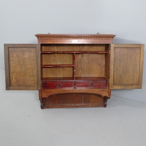 2297 - A 1920s oak hanging cabinet, with linen fold carved panelled doors. 60x62x20cm.