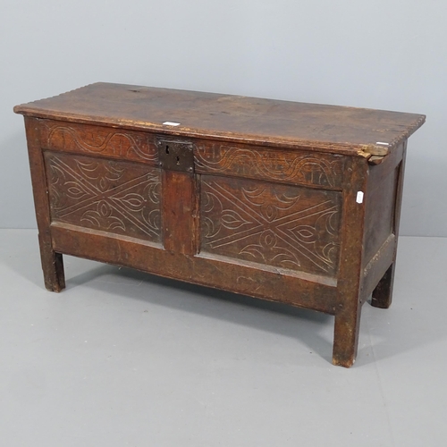 2299 - An 18th century joined oak coffer, with carved panelled front and stile legs. 98x53x39cm.