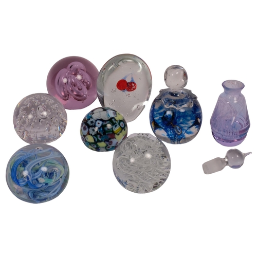 517 - A group of 7 glass paperweights, including Murano and Langham, and a scent flask