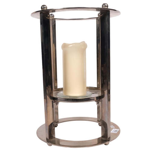 528 - A modernist polished steel candle stand, H41cm overall