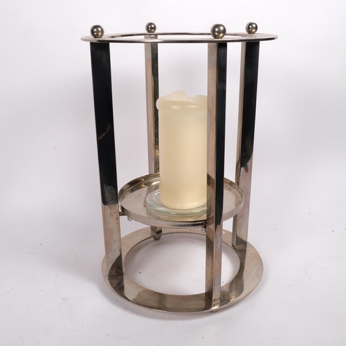 528 - A modernist polished steel candle stand, H41cm overall