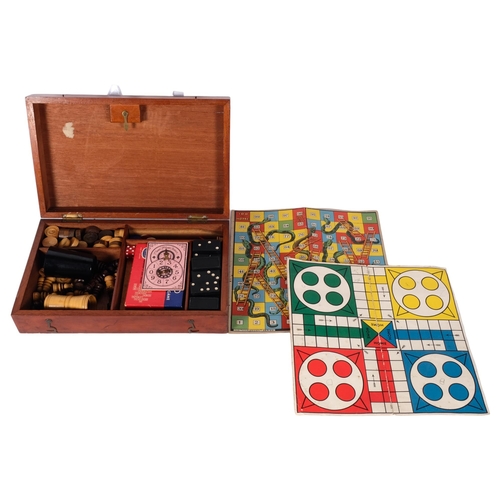 596 - A mahogany boxed games compendium, including dominos, draughts, and chess set etc