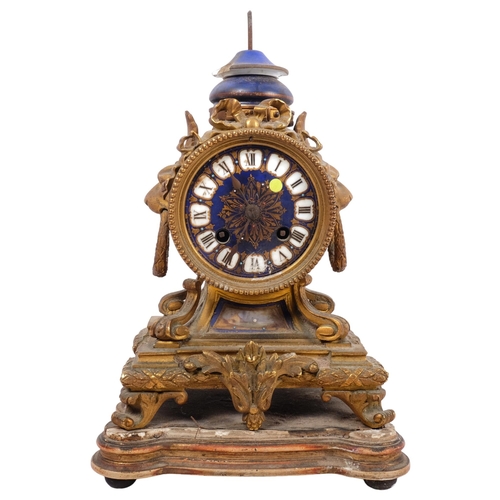 712 - An Antique French gilt-bronze mantel clock, with enamel display, Roman numerals, with base (A/F)