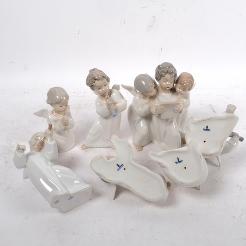 724 - A quantity of Lladro angel porcelain figurines, several playing musical instruments, and a group of ... 