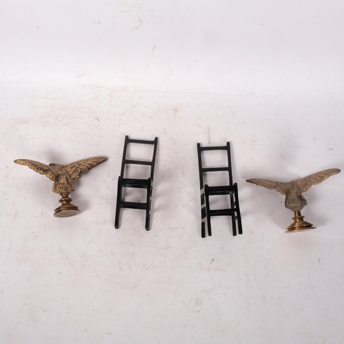 726 - A pair of cast-bronze eagles, wingspan 18cm, and a pair of patinated bronze miniature dining chairs,... 