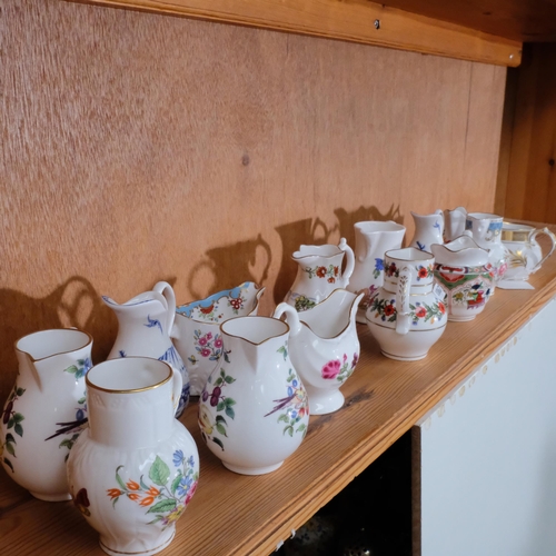 747 - A collection of 14 Royal Worcester miniature porcelain jugs, tallest 8.5cm being the poppy jug