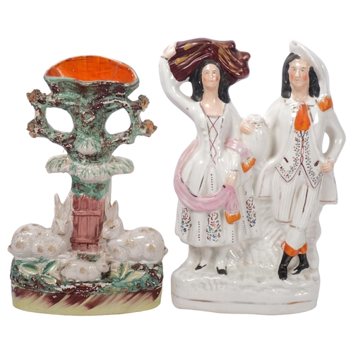 750 - A Victorian Staffordshire couple, and an early Staffordshire spill vase group with 3 rabbits, H28cm