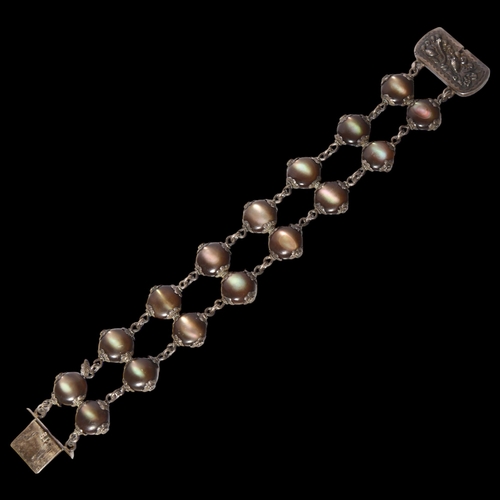 1014 - WANG HING - a Antique silver double panelled bracelet, with embossed clasp