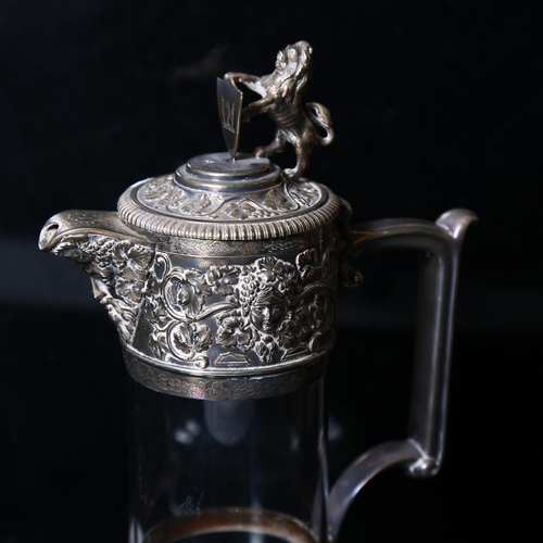 904 - A glass Claret jug, with embossed silver plated mounts and heraldic lion knop, H28cm