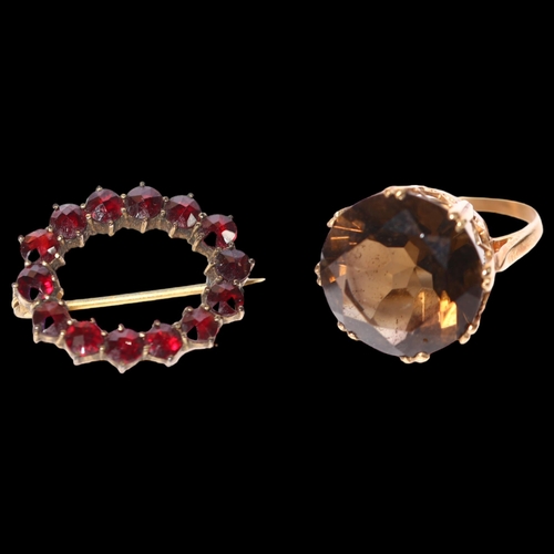 951 - An unmarked gold and citrine set dress ring, and a garnet and gilt-metal set brooch (2)