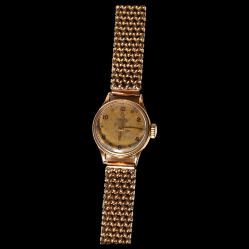 952 - OMEGA - a lady's Omega 9ct gold cased mechanical wristwatch, with a gold plated woven strap