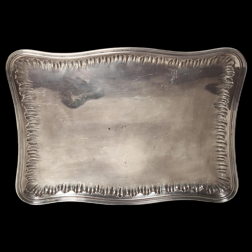 959 - A French silver dressing table tray of serpentine form, with cast decorated edge, W34cm, 18.7oz