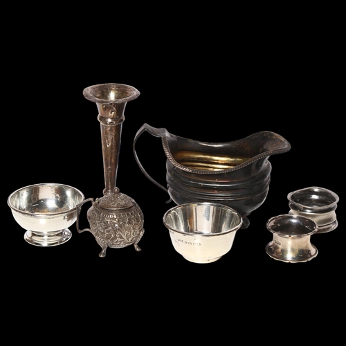 966 - A group of silver items, to include 2 napkin rings, a sauce boat, 2 small dishes, 4.2oz, a small sil... 