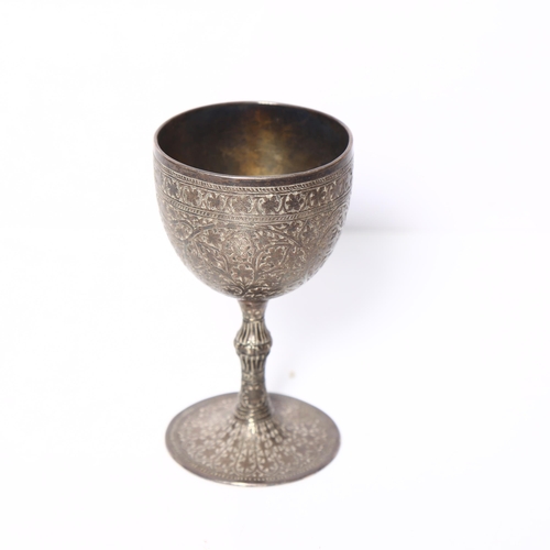 975 - An ornate Persian white metal goblet on turned foot, with allover engraved decoration, H11.5cm, 5.8o... 