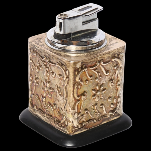 976 - An Elizabeth II embossed silver cased desk lighter, H9cm