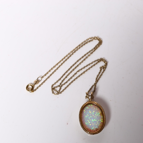 980 - A 9ct gold Gilson synthetic opal pendant necklace, in rope twist surround with 9ct fine cable link c... 