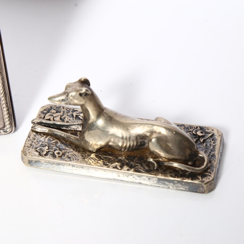 987 - R CARR - a silver-fronted quartz mantel clock, and a silver plated Greyhound design paperweight