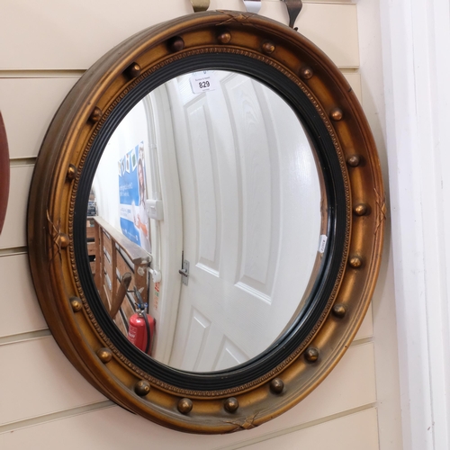 829 - A convex giltwood circular wall-mounted mirror, diameter 52cm