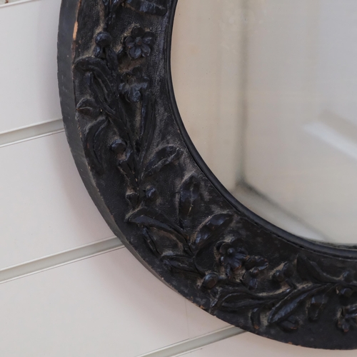 830 - A oval carved wood mirror, with floral carved decoration, 52cm x 62cm