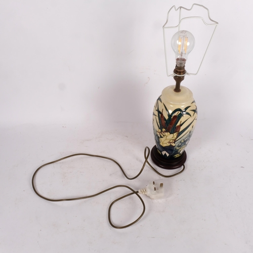 616 - A Moorcroft cream ground table lamp with waterlily and bulrush decoration, height to top of base 28c... 