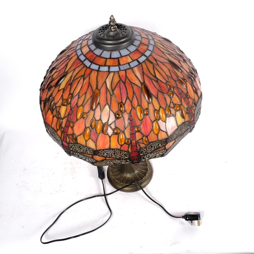 645 - A Tiffany style twin-light table lamp on composition base, with multi-coloured dragonfly design lead... 