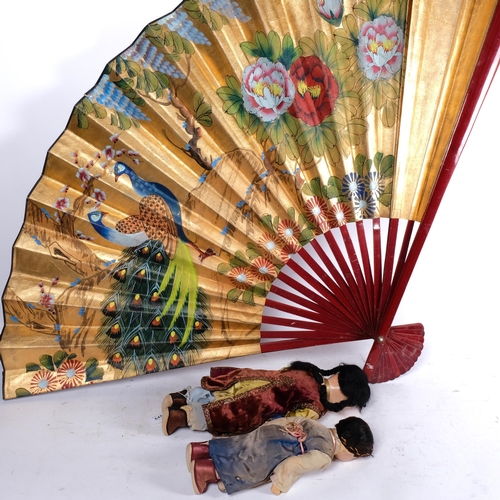 648 - 2 Vintage composition head dolls in Oriental costumes, tallest 38cm, and a large Oriental fan with p... 