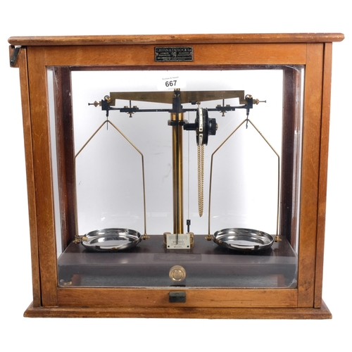 667 - A Griffin & Tatlock cased laboratory scale, with oak frame and sliding door, H40.5cm overall