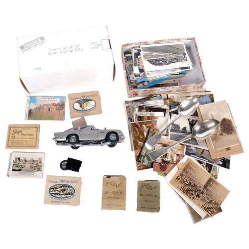 515 - A James Bond DB5, Topographical postcards, a silver tablespoon, and another plated spoon