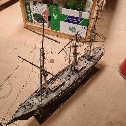 125 - A scratch-built riveted model of the Cutty Sark, with a box of associated accessories and spare part... 