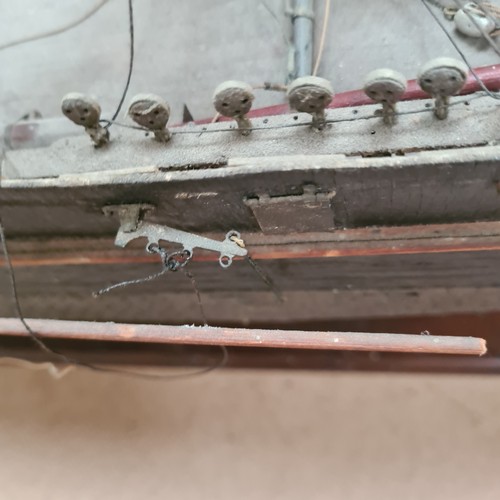 125 - A scratch-built riveted model of the Cutty Sark, with a box of associated accessories and spare part... 