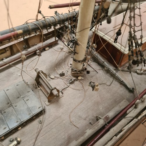 125 - A scratch-built riveted model of the Cutty Sark, with a box of associated accessories and spare part... 