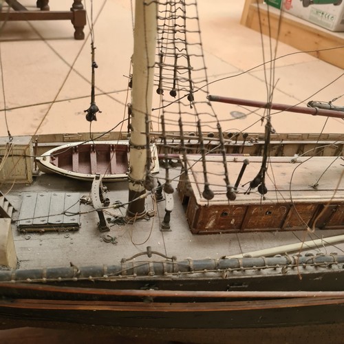 125 - A scratch-built riveted model of the Cutty Sark, with a box of associated accessories and spare part... 