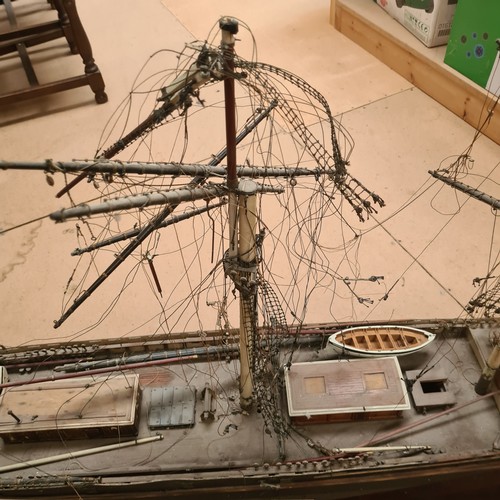 125 - A scratch-built riveted model of the Cutty Sark, with a box of associated accessories and spare part... 