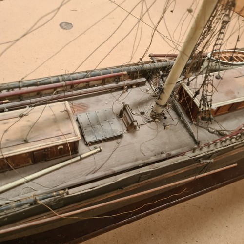 125 - A scratch-built riveted model of the Cutty Sark, with a box of associated accessories and spare part... 