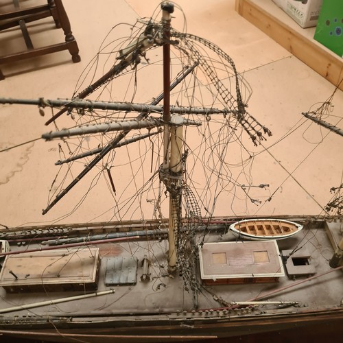 125 - A scratch-built riveted model of the Cutty Sark, with a box of associated accessories and spare part... 