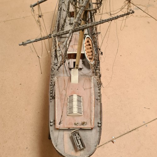 125 - A scratch-built riveted model of the Cutty Sark, with a box of associated accessories and spare part... 