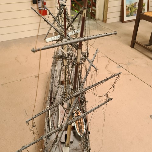 125 - A scratch-built riveted model of the Cutty Sark, with a box of associated accessories and spare part... 