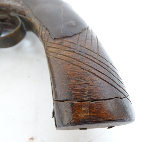 290 - An 18th century percussion pistol, engraved barrel and handle, not working, and a 19th century Middl... 