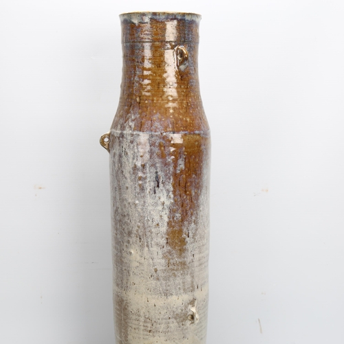 419 - A tall studio pottery vessel with Jun/ash glazes and lugs, marked with fish and JD to base, height 6... 