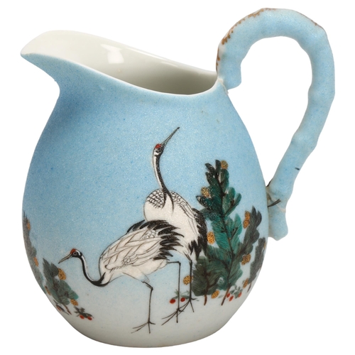 134 - A Japanese porcelain jug with painted cranes, signed under base, height 13cm