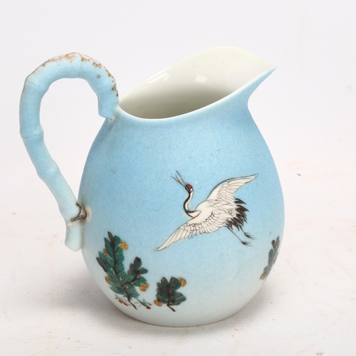 134 - A Japanese porcelain jug with painted cranes, signed under base, height 13cm